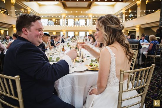 Bride and groom toasting at their Atheneum hotel wedding in Detroit.